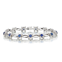 Ladies 18kt White Gold Blue Sapphire and Diamond Flower Bracelet.