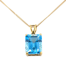 14kt Yellow Gold Blue Topaz Pendant on a Chain.